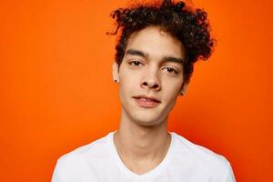 guy in white t-shirt curly hair cropped view studio photo