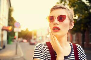 short haired woman outdoors wearing sunglasses fashion summer walk photo