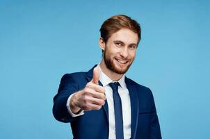 cheerful business man in a suit gesturing with his hands emotions studio photo