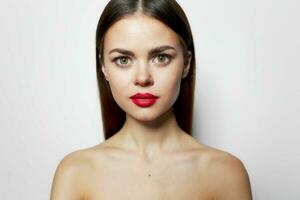 Attractive woman Red lips bared shoulders clear skin close-up bright makeup photo