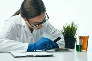 mujer sentado a el mesa investigación biología profesional Ciencias foto