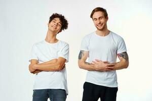 two man in white t-shirts are standing next to friendship emotions photo