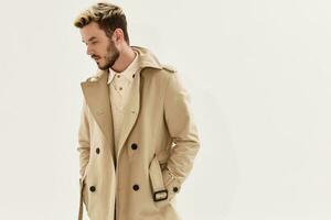 man in coat hands in pocket side view hairstyle modern style photo