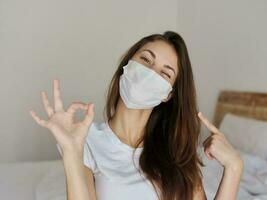 cheerful woman in medical mask hand gesture photo