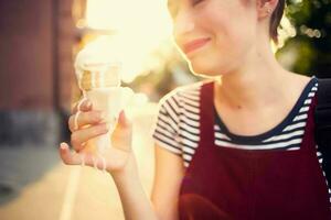 short haired woman outdoors eating ice cream walk lifestyle photo