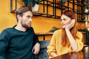 Lovers man and woman at a table in a cafe communication friends family photo