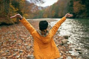 joyful woman in nature Autumn forest river freedom photo