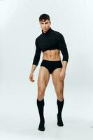 sexy athletes inflated torso in sweater shorts and socks bent to the side photo