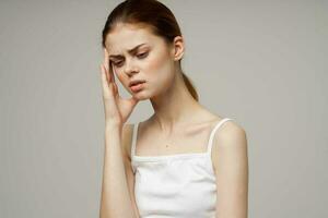 woman in white t-shirt depression symptoms headache studio treatment photo