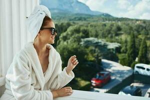 pretty woman in sunglasses at the hotel on the balcony Perfect sunny morning photo
