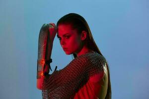 photo pretty woman Glamor posing red light metal armor on hand Lifestyle unaltered
