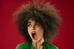 Portrait of a charming lady Afro hairstyle green dress emotions close-up studio model unaltered photo