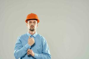 man in orange helmet blueprints builder Working profession photo