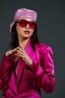 young woman in a pink mini dress fashion glasses pink headscarf luxury isolated background photo