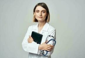 woman doctor with stethoscope and medical gown documents photo