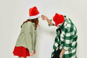 Young couple in Christmas hats holiday fashion studio friendship fun photo