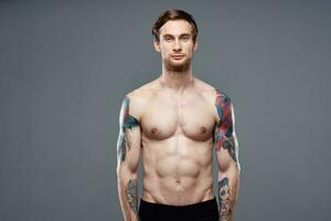 pumped up nude torso men tattoos close-up exercise photo