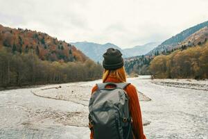 woman travels in the mountains outdoors fresh air beach river landscape mountains photo