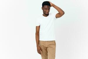 male african appearance in white cropped t-shirt studio photo