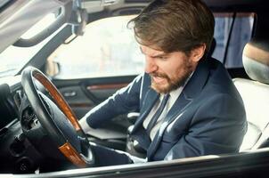 bearded man in a suit in a car a trip to work rich photo