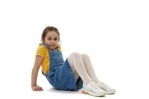 Adorable little child girl, elementary aged little girl, looking at camera, isolated on white background photo