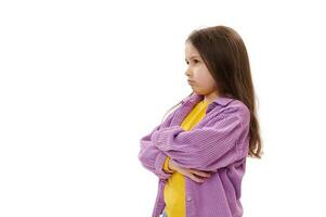 Isolated portrait on white background of a 5-6 years mischievous little child girl, with pouting lips from resentment photo