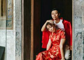 Happy young Asian couple in Chinese traditional dresses photo