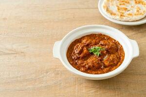 chicken tikka masala spicy curry meat food with roti or naan bread photo