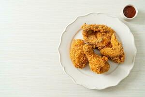 fried chicken with ketchup on plate photo