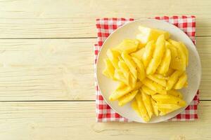 fresh pineapple sliced on plate photo