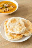 Chicken curry soup with roti photo