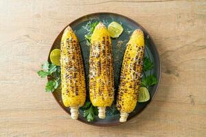 barbecue and grilled corn with cheese and lime photo