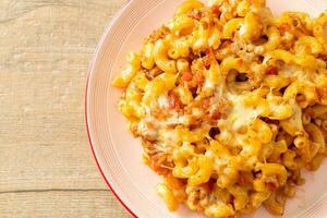 homemade macaroni bolognese with cheese photo