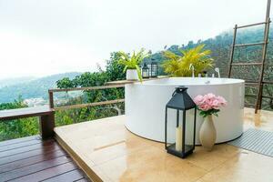 outdoor bath tub with beautiful mountain view background photo