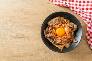 pork bulgogi rice bowl with kimchi and Korean pickled egg photo