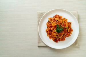 farfalle pasta in tomato sauce with parsley photo