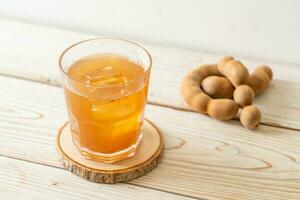 Delicious sweet drink tamarind juice and ice cube photo