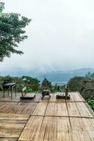 chair on balcony with mountain hill and foggy background photo