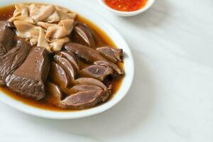 stewed duck offal in brown soup photo