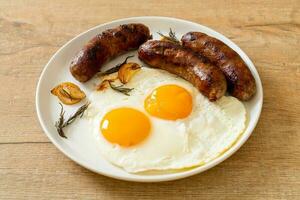 double fried egg with pork sausage photo