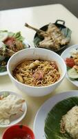 Close up of Asian man eating fried noodle and vegetable in restaurant photo