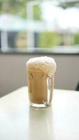 Cup of coffee with foam on the head of a mannequin photo