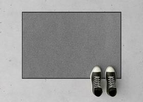 Blank gray door mat on the floor at home. Welcome mat with copy space for your text. Doormat mock up. Carpet at entrance for wiping dirty shoes. Mockup. 3D Rendering. photo