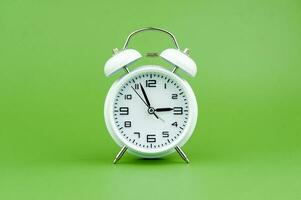 clock precious time alarm clock on green background concept of time working with time photo