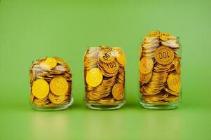 gold coins in a glass jar saving money coin coin bank income wages expenditure money financial stability photo