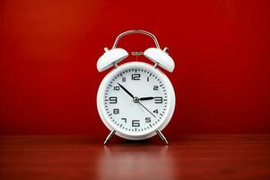 clock precious time alarm clock on red background concept of time working with time photo