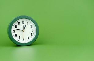 clock precious time alarm clock on green background concept of time working with time photo