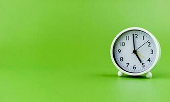 clock precious time alarm clock on green background concept of time working with time photo