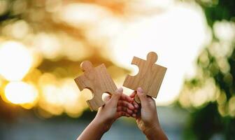 jigsaw in hand puzzle pieces gather together teamwork The concept of planning work as a team. photo