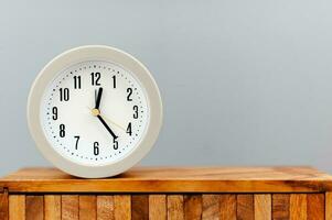 Alarm clock placed on a wooden plank working with time concept of time value of time photo